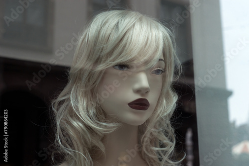portrait on blond mannequin in a fashion store showroom