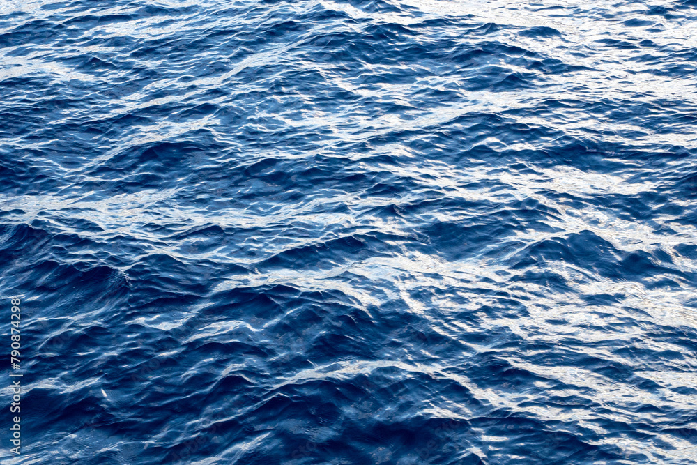 Blue water. Waves at sea. Beautiful river abstract wallpaper with waves pattern