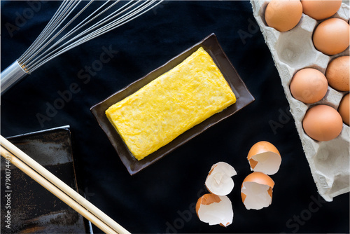 tamago yaki top view with the kitchenware  and ingredients.egg roll (omelette) japanese style.
