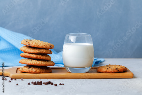 Heap Of Oats Cookies With Chocolate Drops, Honey And Glass Of Milk. Side View On Grey Background.