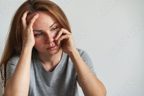 Frustrated woman rested her head on her hand. Women's health problems and mental illness concept.