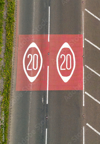 Drone view of road markings in Wales showing the start of a 20mph speed limit zone. photo