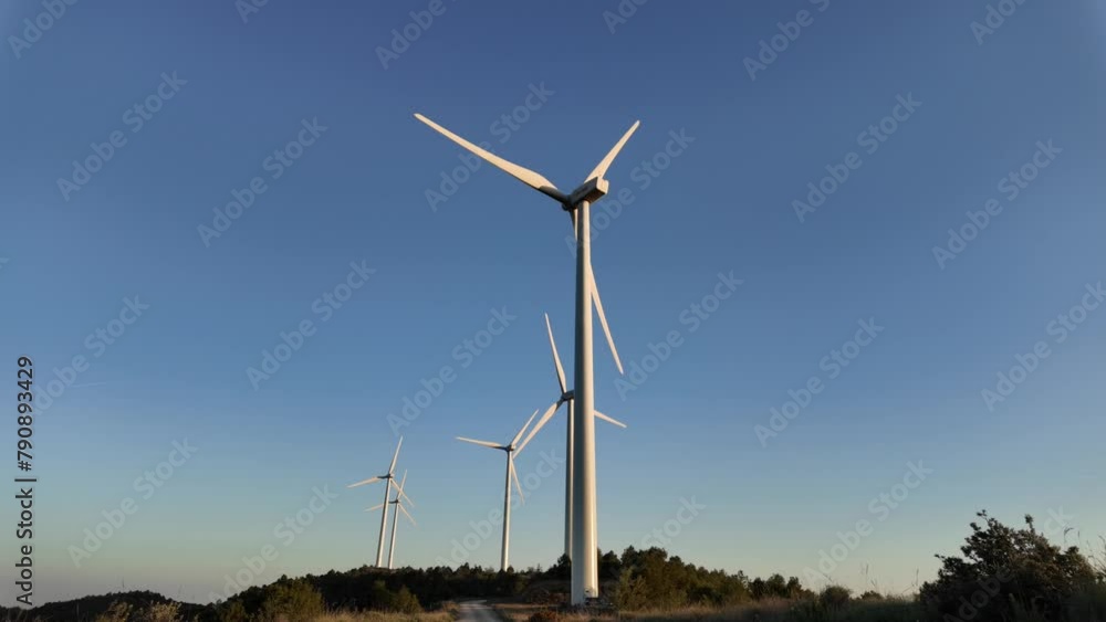 POV of a line of massive wind turbines, illustrating the concept of ecological transition, renewable energy, and climate change awareness POV of a line of massive wind turbines, illustrating the concept of ecological transition, renewable energy, and climate change awareness