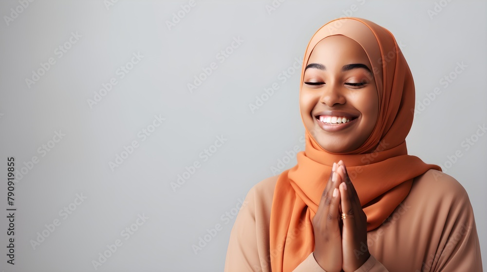Portrait of a beautiful black muslim woman wearing a headscarf on grey background Portrait of a beautiful black muslim woman wearing a headscarf on grey background