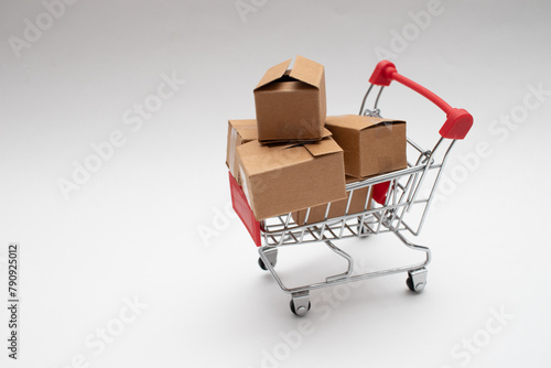 Cardboard boxes in a small shopping cart. Online shopping
