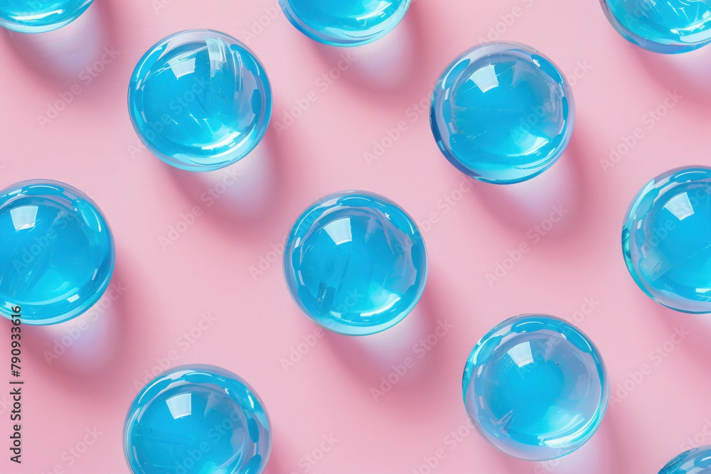 Beautiful Blue Glass Balls Arranged on Vibrant Pink Background with Blue Sky, Creative Decor Concept Beautiful Blue Glass Balls Arranged on Vibrant Pink Background with Blue Sky, Creative Decor Concept