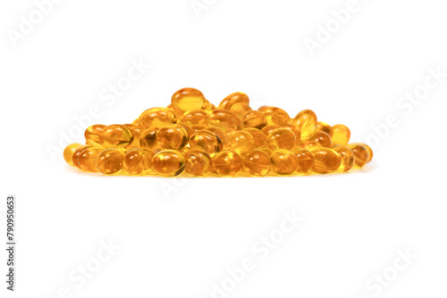 A group of yellow capsules isolated on a white background. © Nikolay