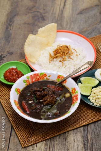 nasi rawon, Indonesian black beef soup with rice.  photo