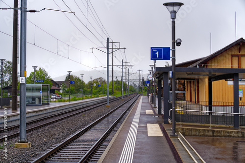 Railway station of Swiss village of Stammheim with tracks and overhead contact line on a rainy spring afternoon. Photo taken April 21st, 2024, Stammheim, Canton Zürich, Switzerland.