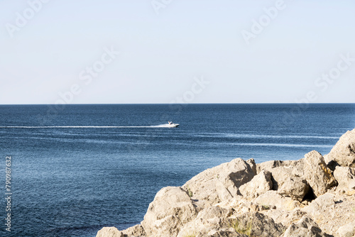 boat in the sea bay at the foot of the mountains
