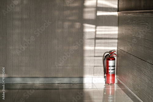 old fire extinguisher put on the conner of the meeting room in the sunshine from out side photo