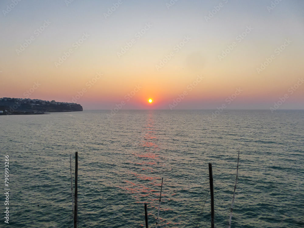 Obraz premium Panoramic sunset view at the Gargano Coast, Apulia, Italy, Europe. Romantic summer vibes at the Mediterranean Adriatic sea. Tranquil calm atmosphere on the beach. Luxury resort in Southern Italy
