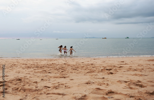 group of happy pretty women in bikinis Ran up from the sea Holiday Vacation and having fun