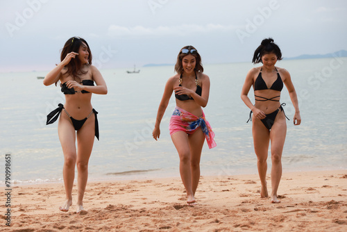 group of happy pretty women in bikinis Ran up from the sea Holiday Vacation and having fun