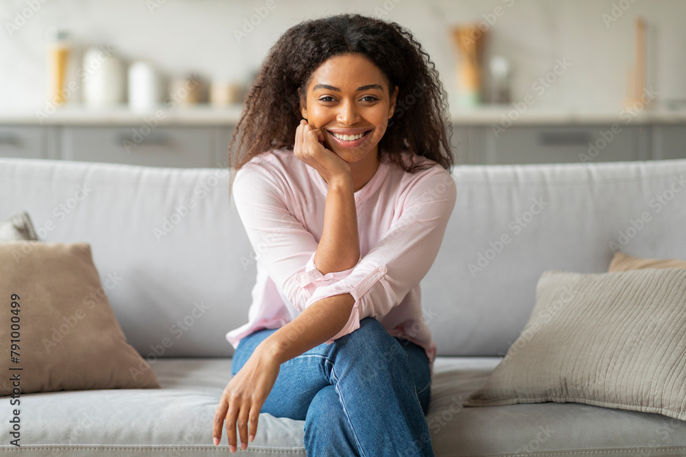 Woman sitting with crossed legs on couch Woman sitting with crossed legs on couch