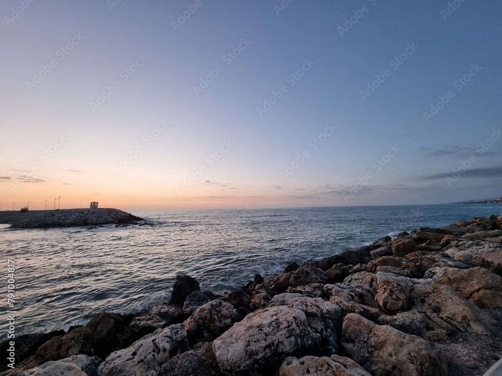 Endless View Of Ocean With Rocks On The Sunset