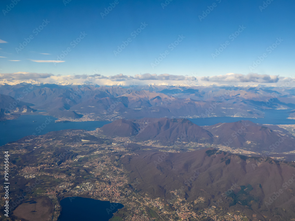 Aerial panoramic view of the Lake Lago di Como and Lago Maggiore seen from a commercial flight. Norther Italy region of Lombardy. The lakes are covered by snow capped mountain peaks of the Alps