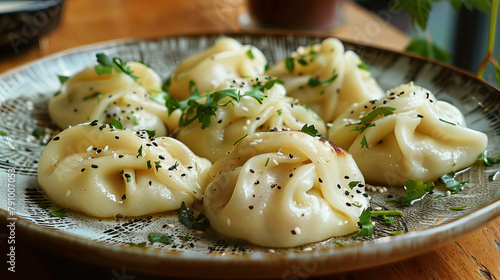 Very tasty manti left on a plate, sprinkled with herbs