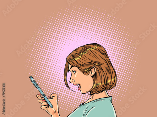 A happily surprised girl looks at the phone. Congratulations on winning the lottery. Amazingly profitable offer on the Internet.