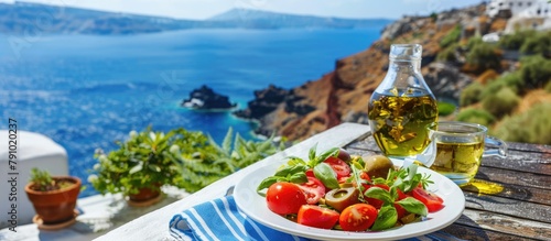 The idea of Greek cuisine in summer is portrayed through a Greek salad featuring olive oil and tomatoes, enjoyed against the backdrop of a stunning view of the blue Aegean sea.