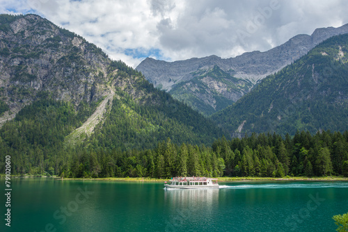  ship floats on the lake in mountains                             