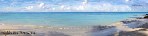 Tropical panorama beach with white clouds and blue caribbean sea.