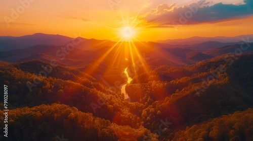   The sun sets over mountains, trees in foreground, river in frame #791028097
