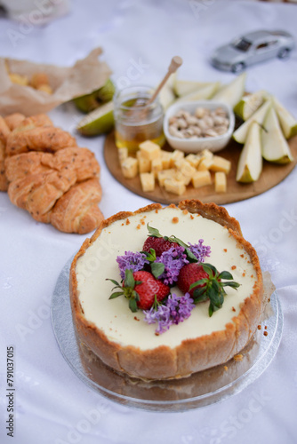 Cake on summer picnic with strawberry and lilac