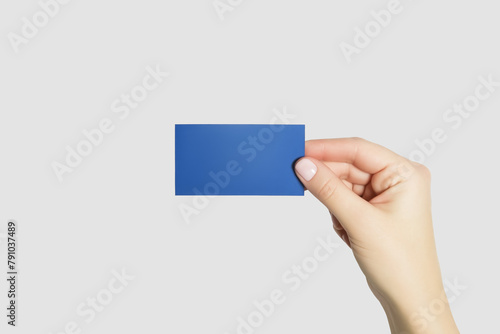 hand holding blue business card isolated on gray background