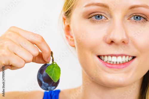 Girl holds plum fruit