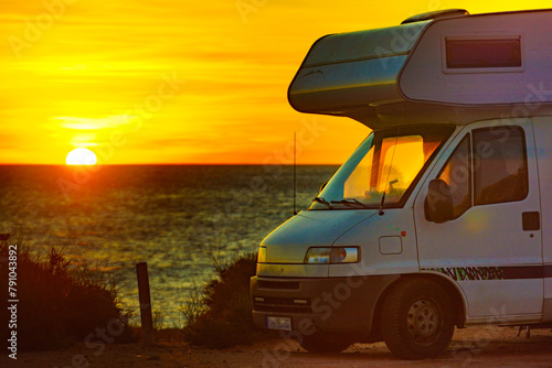 Caravan on beach at sunrise