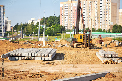 Construction site.Equipment for installing piles in the ground, a heavy machine for driving pillars work when laying the foundation of the building.