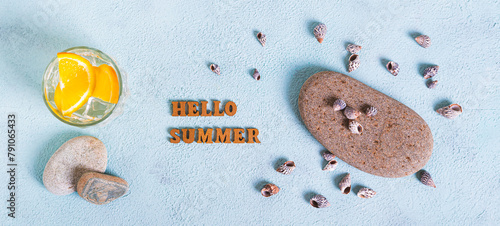 Concept hello summer text, cocktail, stones and shells on blue top view web banner