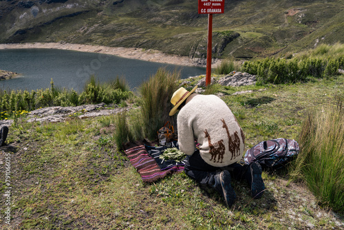 Andean man performing ritual of payment to the land in Peru, payment to the Pachamama photo