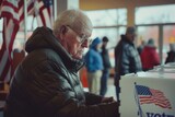 Senior US citizen at voting booth at polling station.