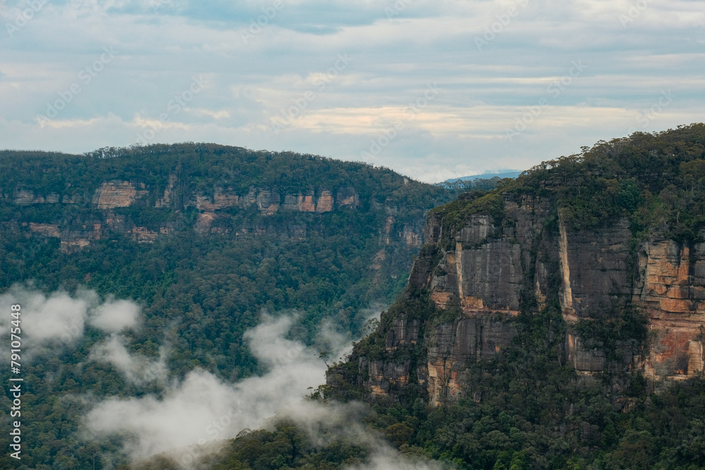 Majestic Vistas: Blue Mountains with Cloud-Drifted Valleys