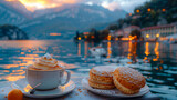 Cup of coffee and a dessert on the background of a lake
