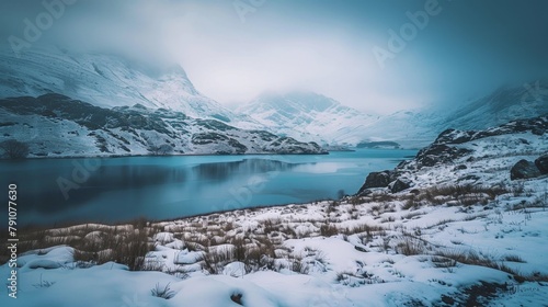 Snowy mountains and lake in winter landscape