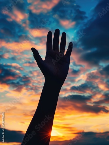 A hand is raised in the air, with the sun shining on it, creating a beautiful