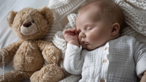 A newborn baby peacefully sleeps next to a soft teddy bear, showcasing tiny hands and feet