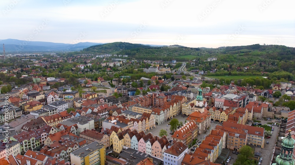 Aerial perspective reveals Jelenia Góra's vibrant marketplace and elegant town hall.