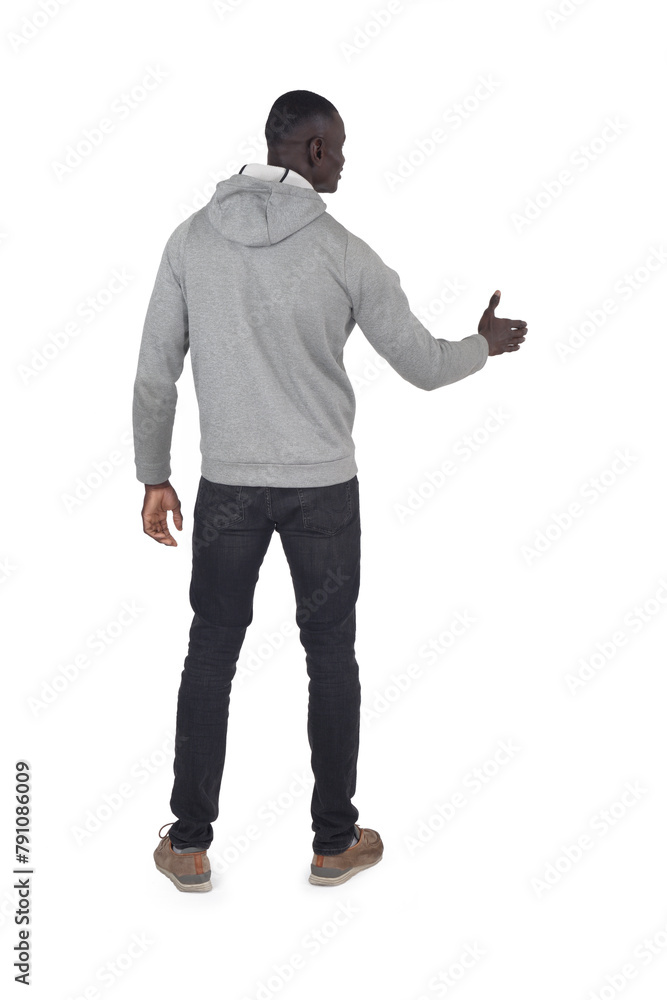 Fototapeta premium back view of a man shaking hands with an imaginary person on white background