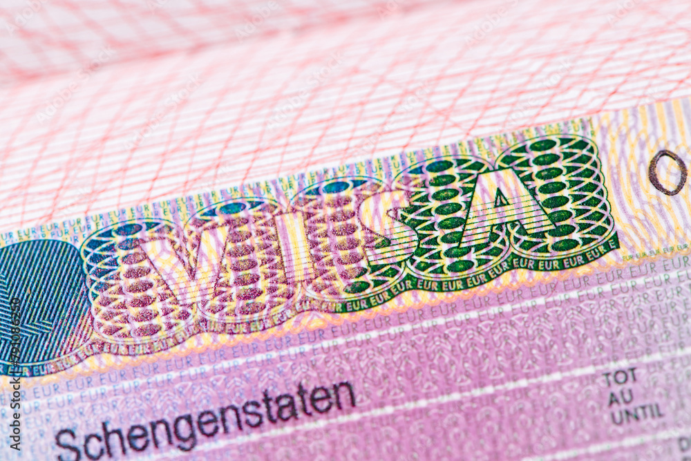 Obraz premium Europe schengen visa in the passport. Close up view. Visa stamp in passport or tourism and travel in EU.