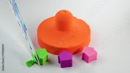 Very Satisfying and Relaxing Kinetic Sand ASMR. Cutting anti stress macro close up colorful Kinetic Sand with a Knife. Kinetic sand cutting with a knife on a black background. ASMR .