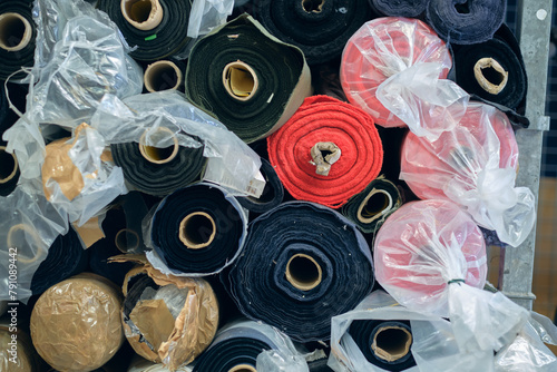 Rolls of raw denim sheets fresh off a production line in a denim factory. Industrial fabric and fashion manufacture. Stylish blue denim fabric for wholesale and jeans. Iconic blue pants.