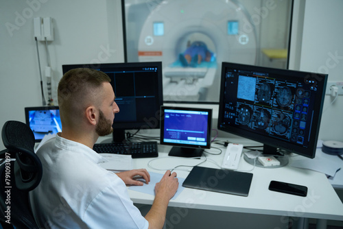MR tech performing magnetic resonance imaging of head