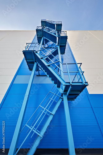 Emergency blue ladder on the wall of building