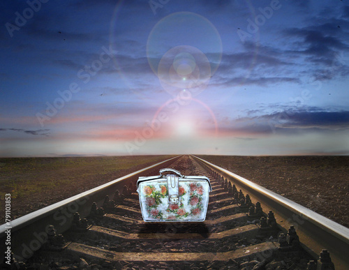 old suitcase standing on rails. Farewell to old life. Travel symbol © alexmak