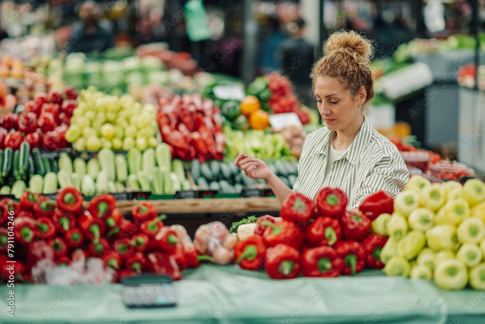 Portrait of female customer purchasing fresh organic vegetables.