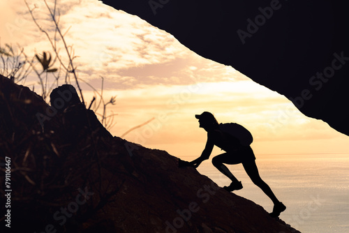 Hiker climbing up mountain cliff, never give up, people perseverance, taking risk 